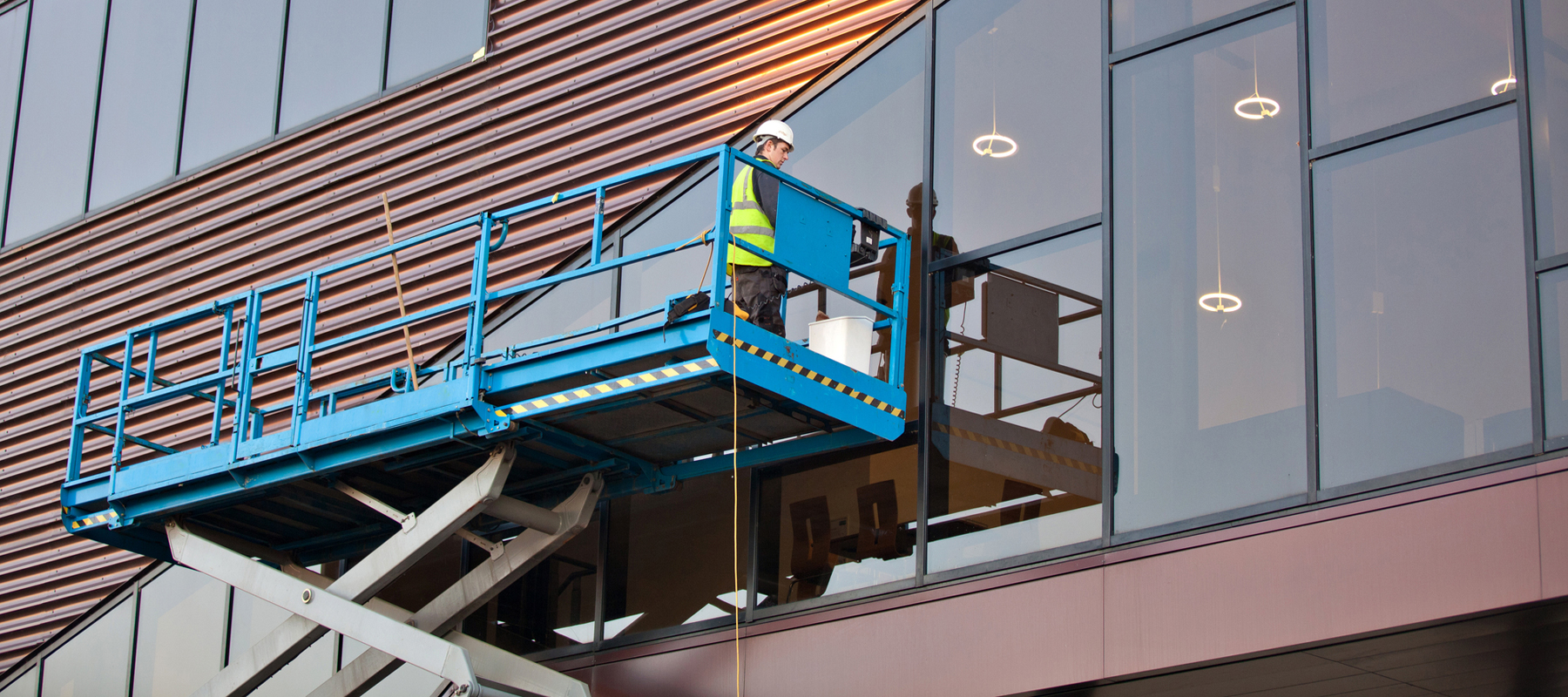 Man on a Scissor Lift Working Construction