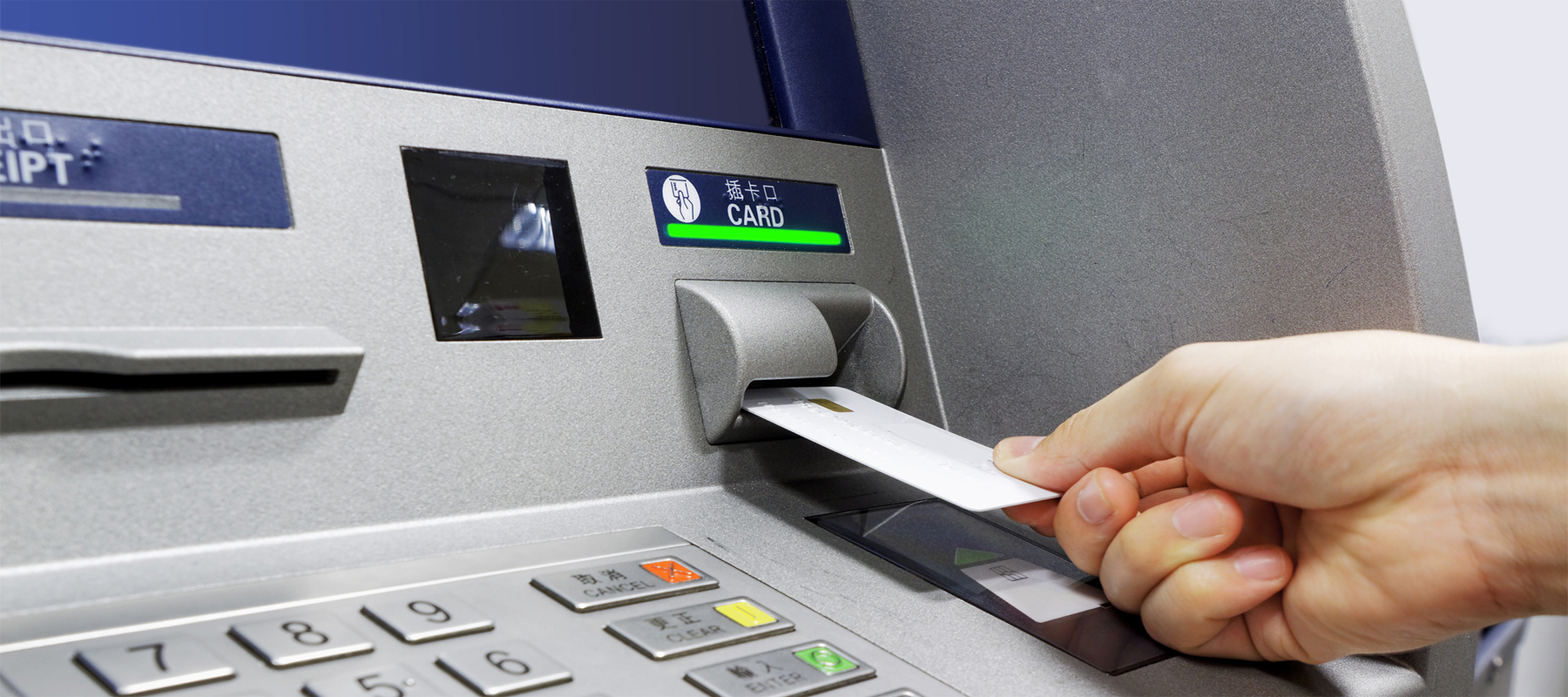 A Freestanding ATM Machine with Person Using Card