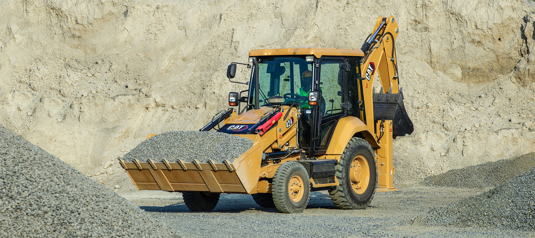 Cat Backhoe Loader Digging in Sand