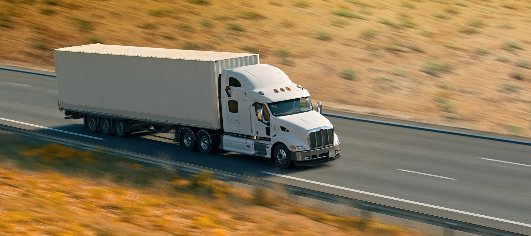 A Leased Semi Truck Driving Fast Down a Highway