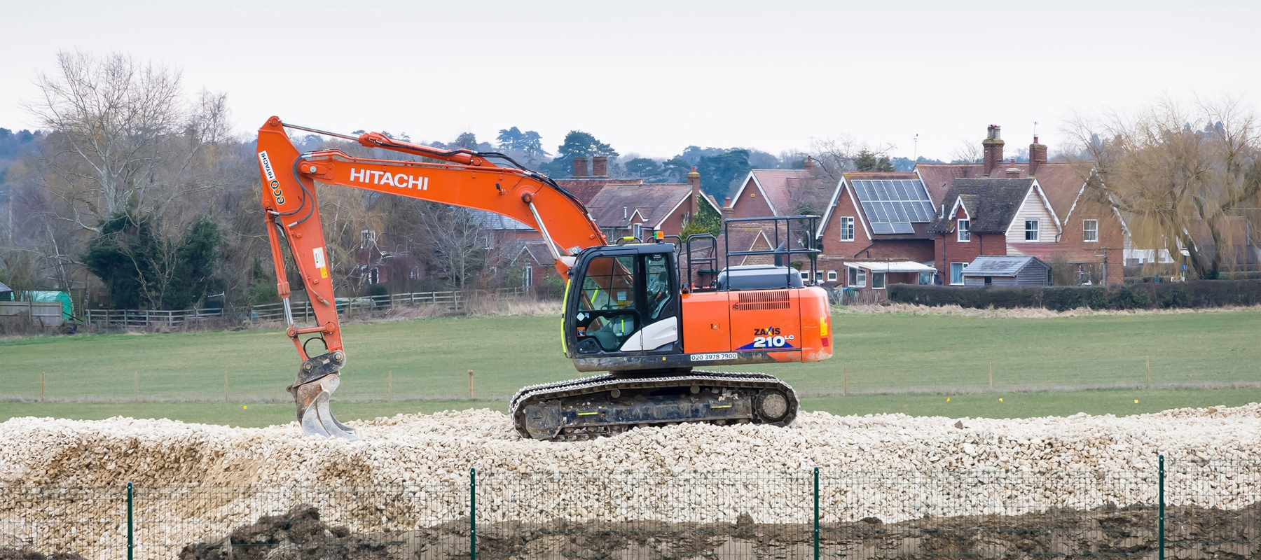 Large Orange Hitachi Excavator Digging
