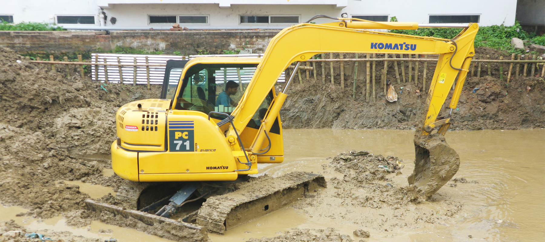 Komatsu Excavator Digging in Mud