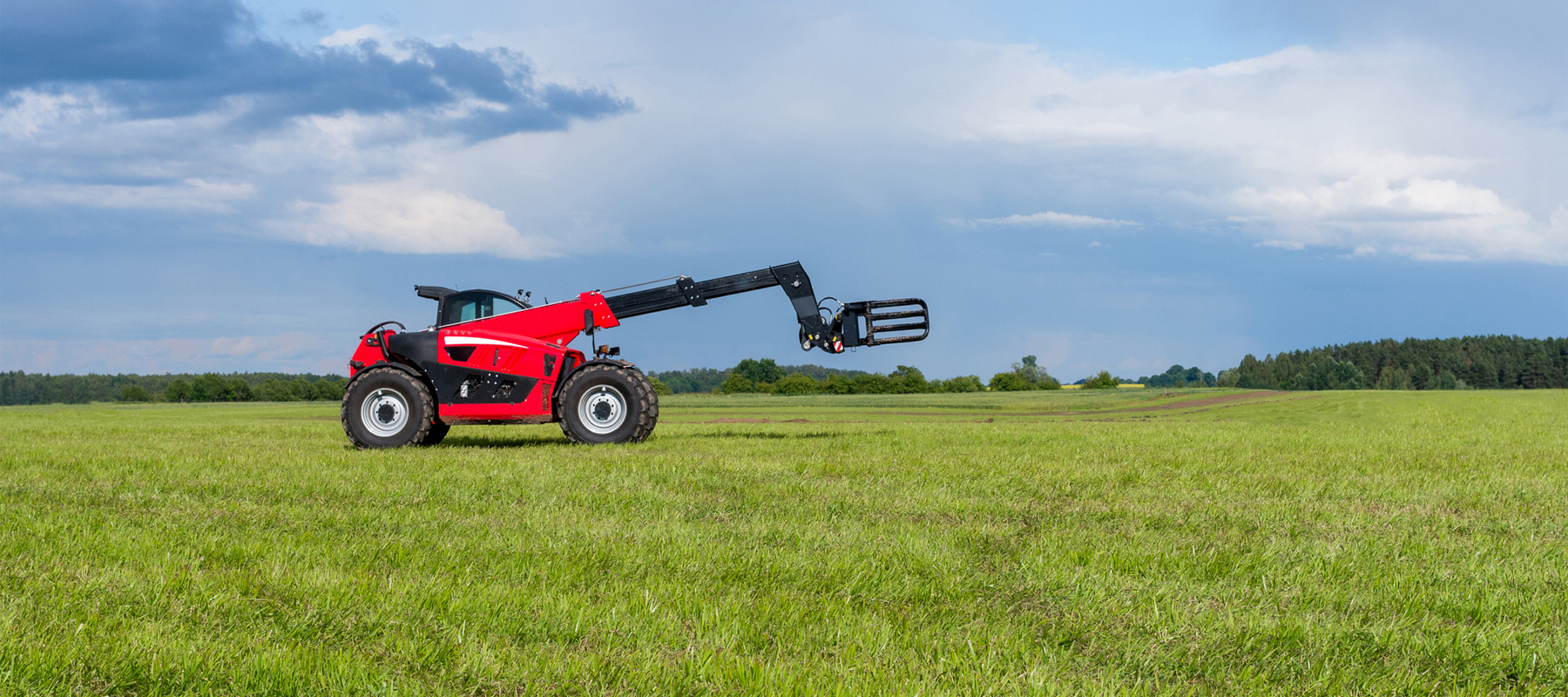 Red Telescopic Telehandler Forklift in a field